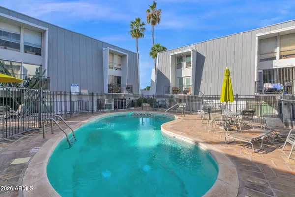 a swimming pool with outdoor seating