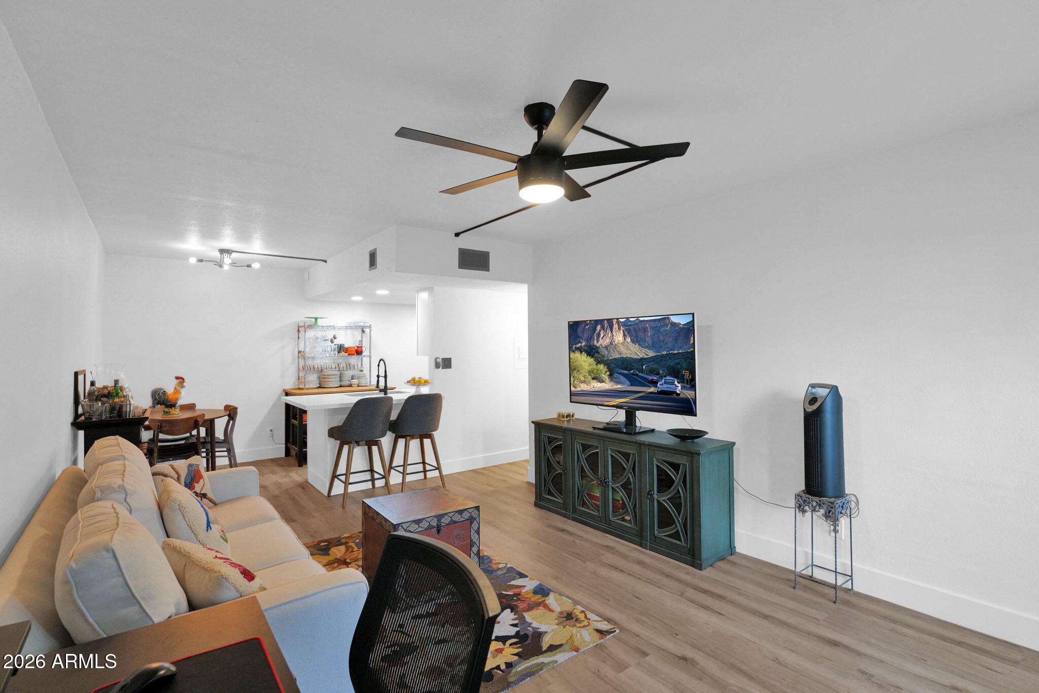 3416 North 44th Street, Unit 69 Phoenix, AZ 85018 - Photo 8 of 19 a living room with furniture and a flat screen tv