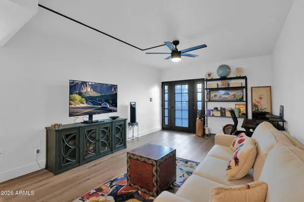 a living room with furniture a flat screen tv and a bookshelf