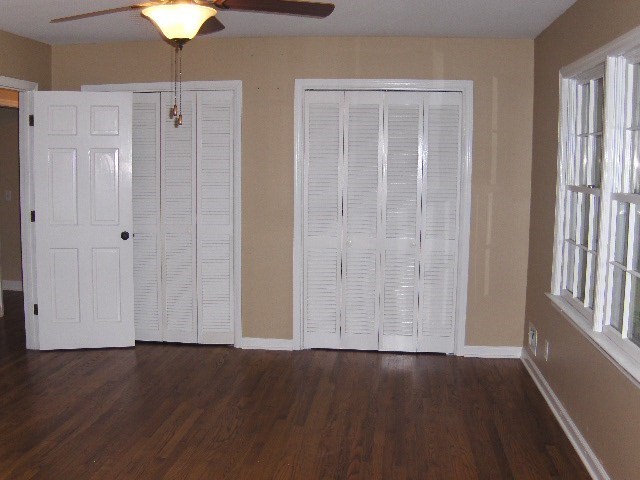4660 Arkwright Road Macon, GA 31210 - Photo 14 of 32 an empty room with wooden floor closet fan and windows