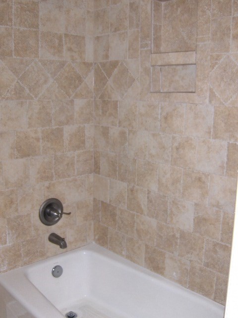 4660 Arkwright Road Macon, GA 31210 - Photo 18 of 32 a bathroom with a tub