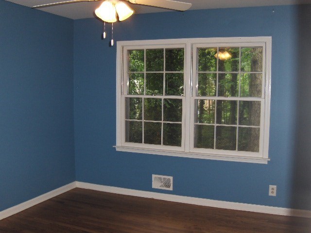 4660 Arkwright Road Macon, GA 31210 - Photo 20 of 32 a view of an empty room with wooden floor and a window