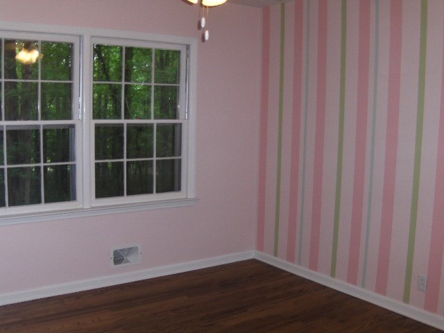 4660 Arkwright Road Macon, GA 31210 - Photo 21 of 32 a view of an empty room with wooden floor and a window