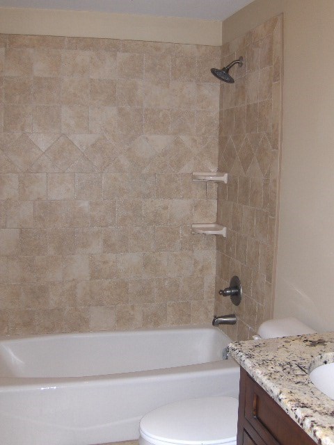 4660 Arkwright Road Macon, GA 31210 - Photo 24 of 32 a bathroom with a granite countertop bathtub shower and toilet