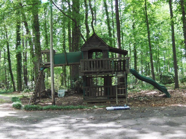 4660 Arkwright Road Macon, GA 31210 - Photo 29 of 32 a view of a wooden house with a small yard