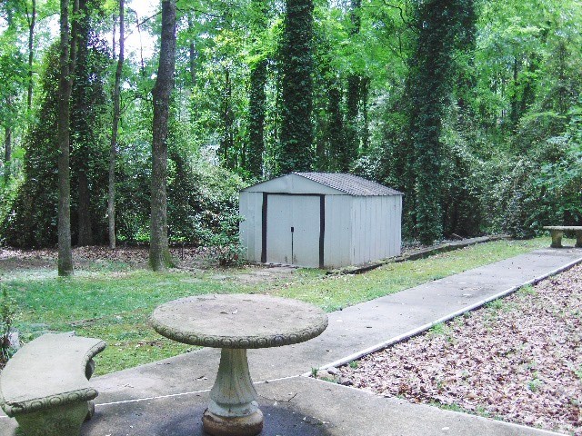 4660 Arkwright Road Macon, GA 31210 - Photo 31 of 32 a view of a house with a backyard and a yard