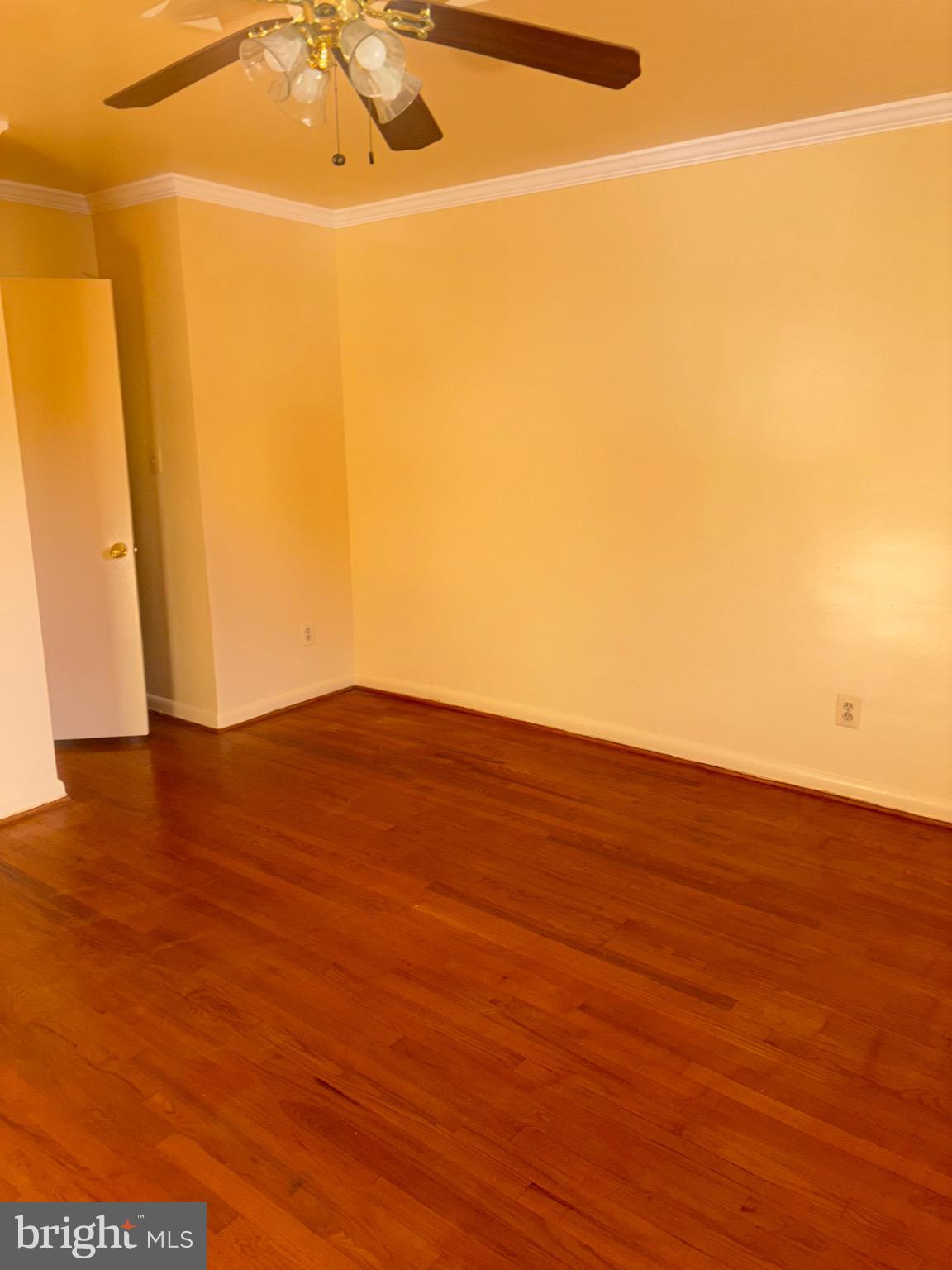 7044 Eastern Avenue Northwest Washington, DC 20012 - Photo 13 of 18 a view of an empty room with wooden floor and a window