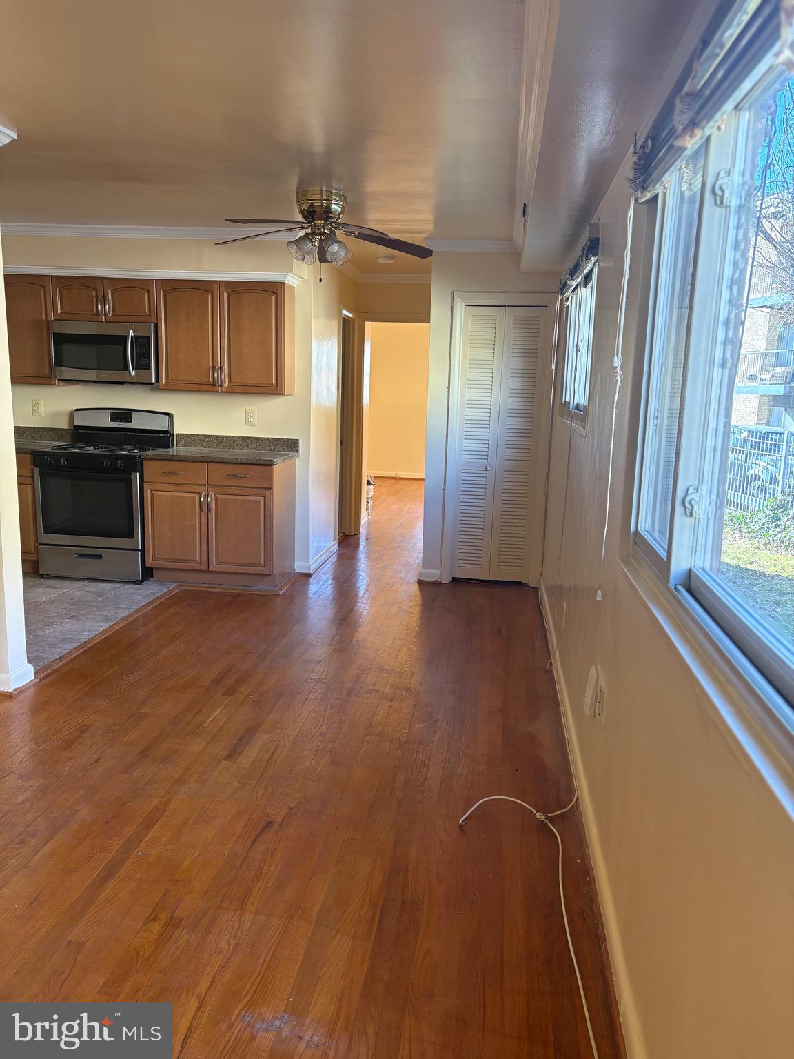 7044 Eastern Avenue Northwest Washington, DC 20012 - Photo 6 of 18 a view of a kitchen with a sink a microwave and cabinets