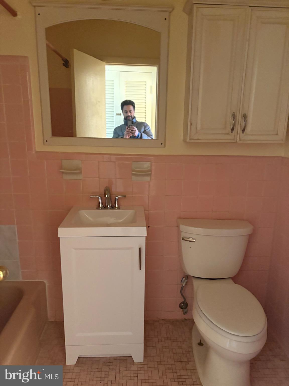 7044 Eastern Avenue Northwest Washington, DC 20012 - Photo 9 of 18 a bathroom with a toilet a sink and mirror