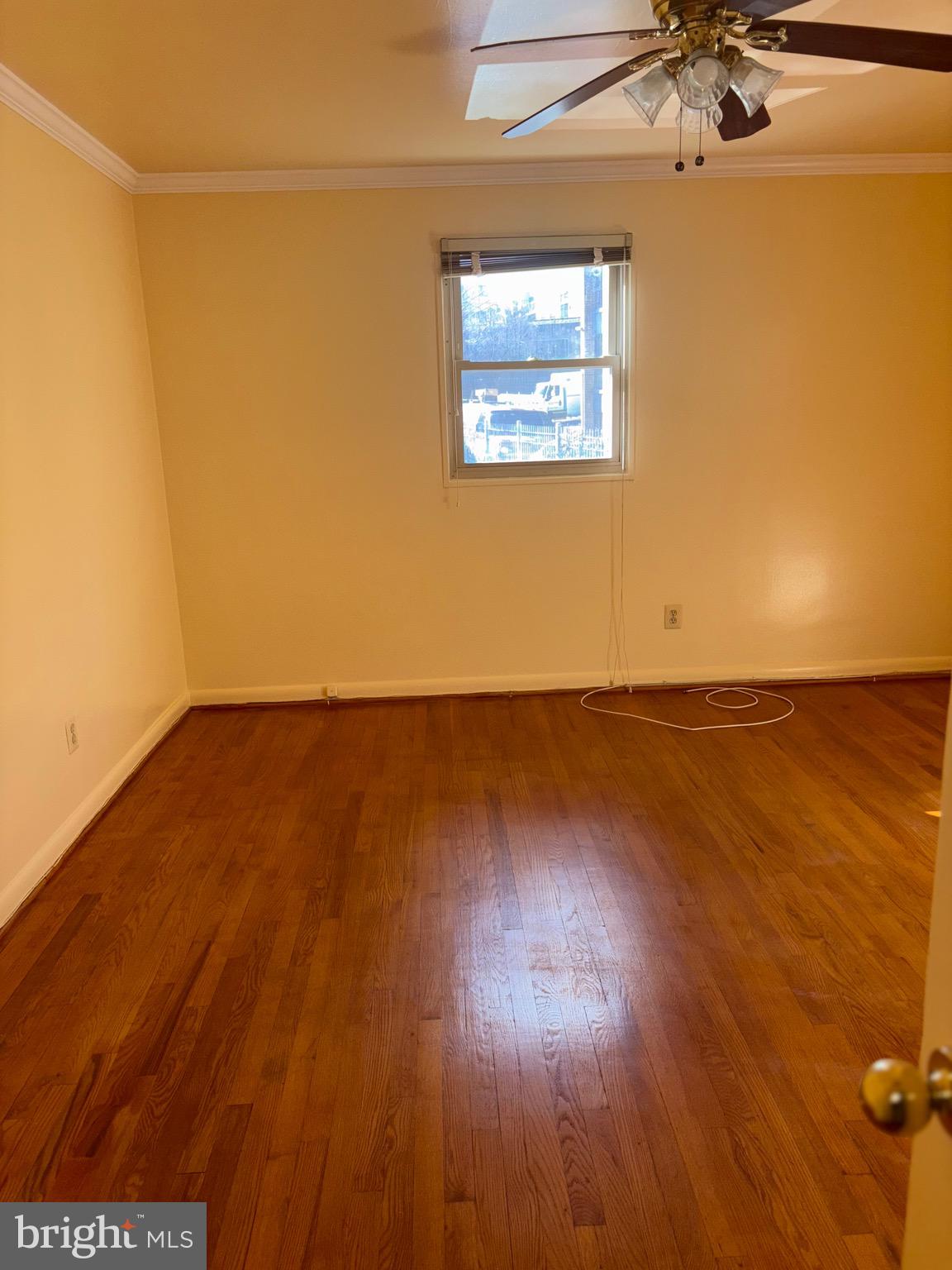7044 Eastern Avenue Northwest Washington, DC 20012 - Photo 10 of 18 an empty room with wooden floor and windows