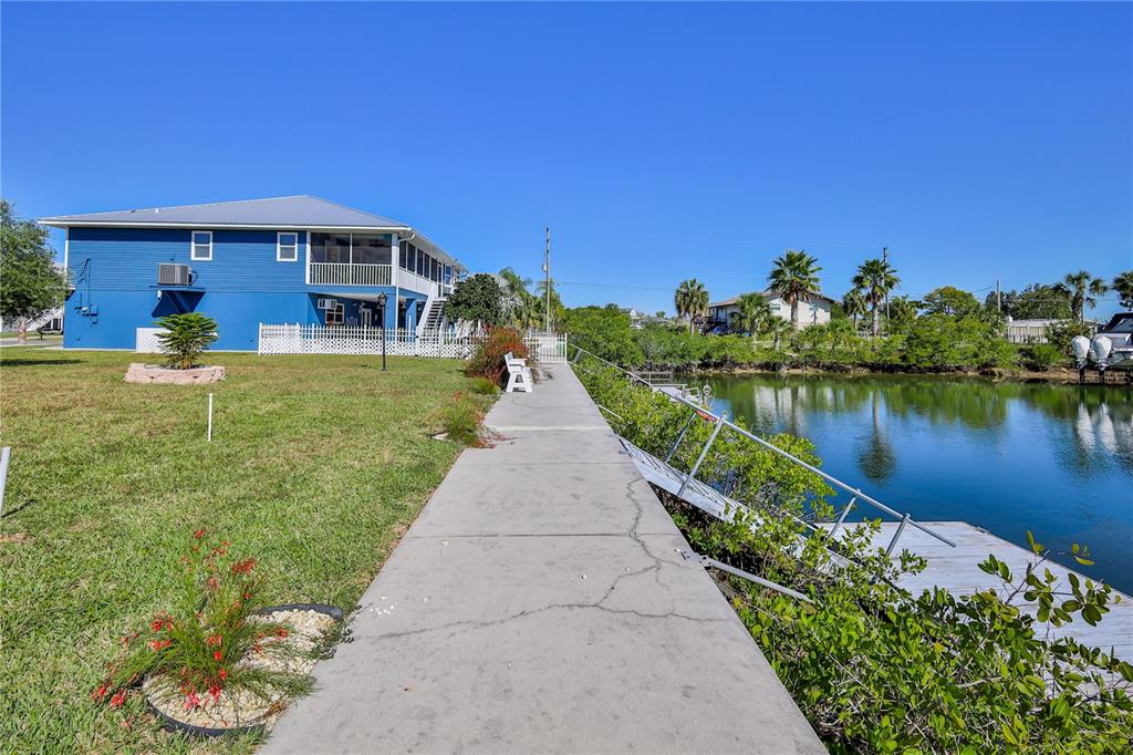 4502 Bahama Drive Hernando Beach, FL 34607 - Photo 19 of 28 a view of a house with a yard and potted plants