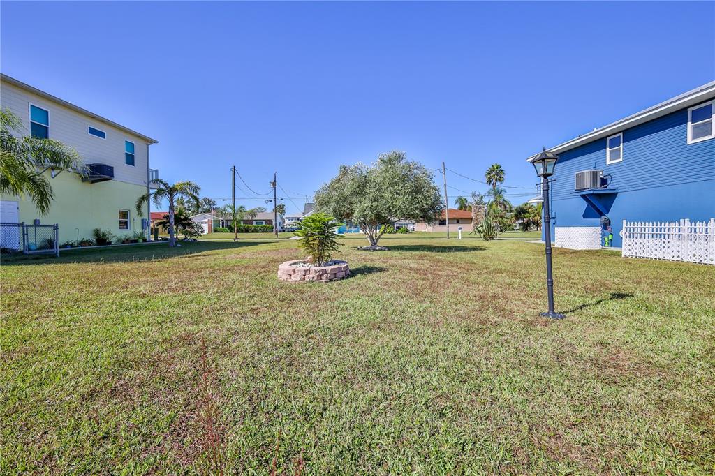 4502 Bahama Drive Hernando Beach, FL 34607 - Photo 20 of 28 a backyard of a house with lots of green space