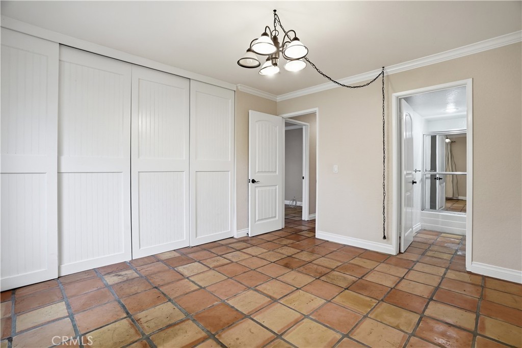 20702 El Toro Road, Unit 231 Lake Forest, CA 92630 - Photo 12 of 36 a view of a room with a chandelier fan and closet area