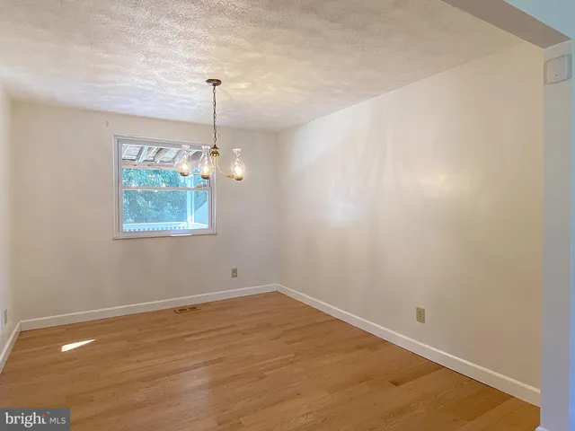 a view of a room with wooden floor and window