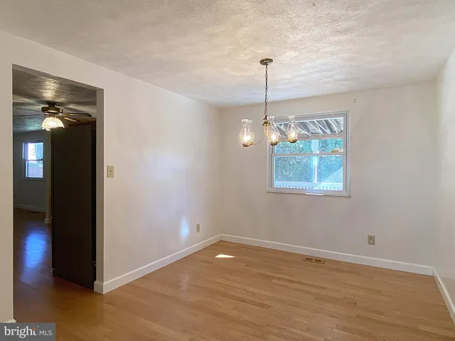 a kitchen with stainless steel appliances granite countertop a sink a stove a microwave a counter space and cabinets