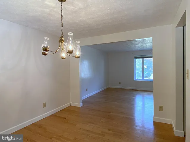 an empty room with a kitchen and a window