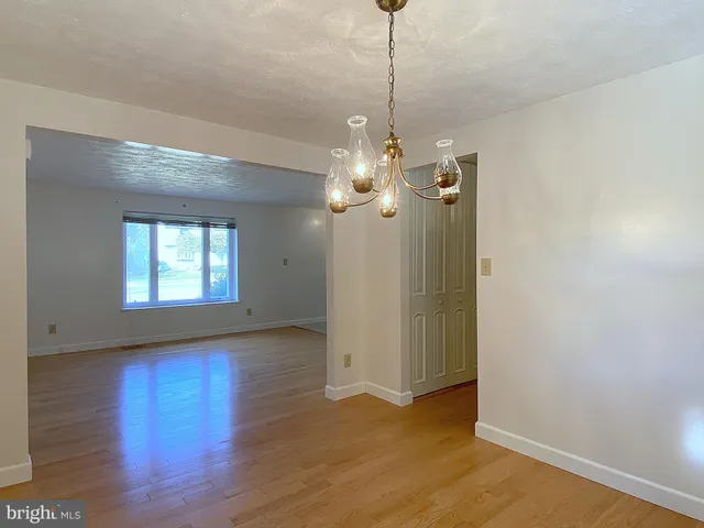a bathroom with a sink a light fixture and a mirror