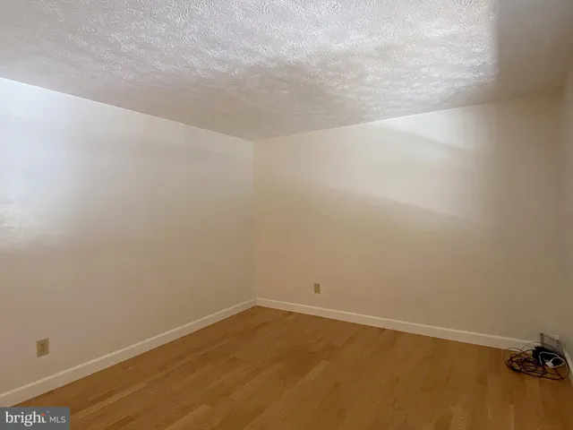 a view of an empty room and wooden floor