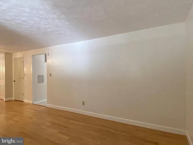 a view of room with hardwood floor and ceiling fan