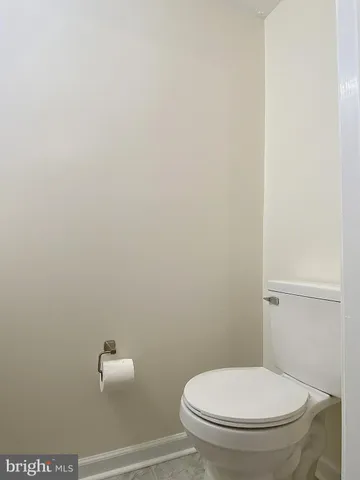 a view of empty room with wooden floor and door