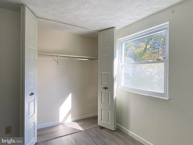 a view of an empty room with wooden walls