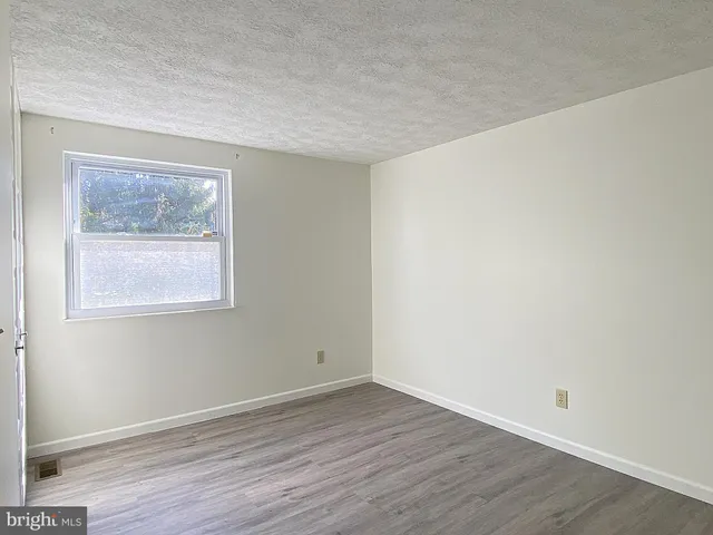 a view of a balcony with a floor to ceiling window and a ceiling fan