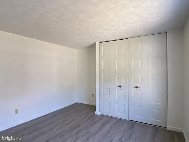 a house view with swimming pool in front of it