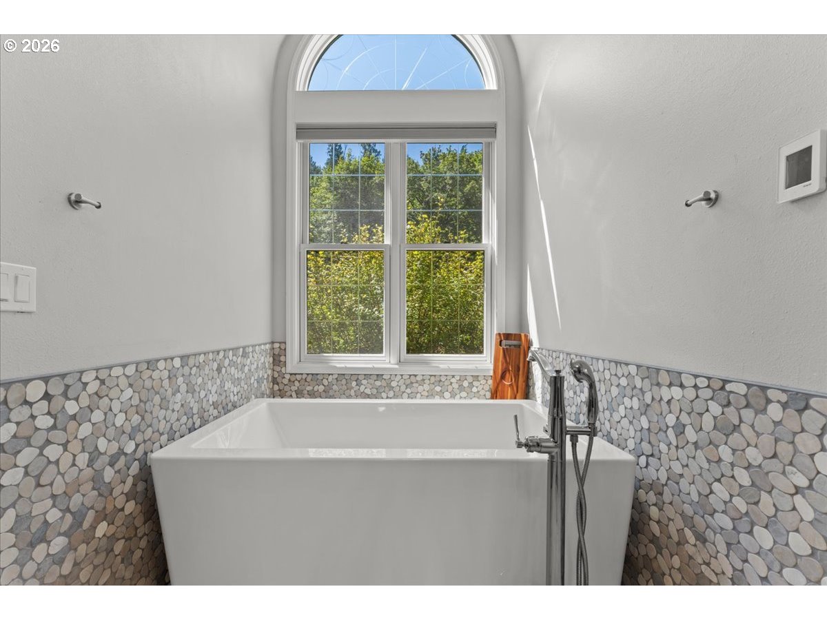 37123 Northeast Reed Road Corbett, OR 97019 - Photo 25 of 48 a bathroom with a bathtub and a shower