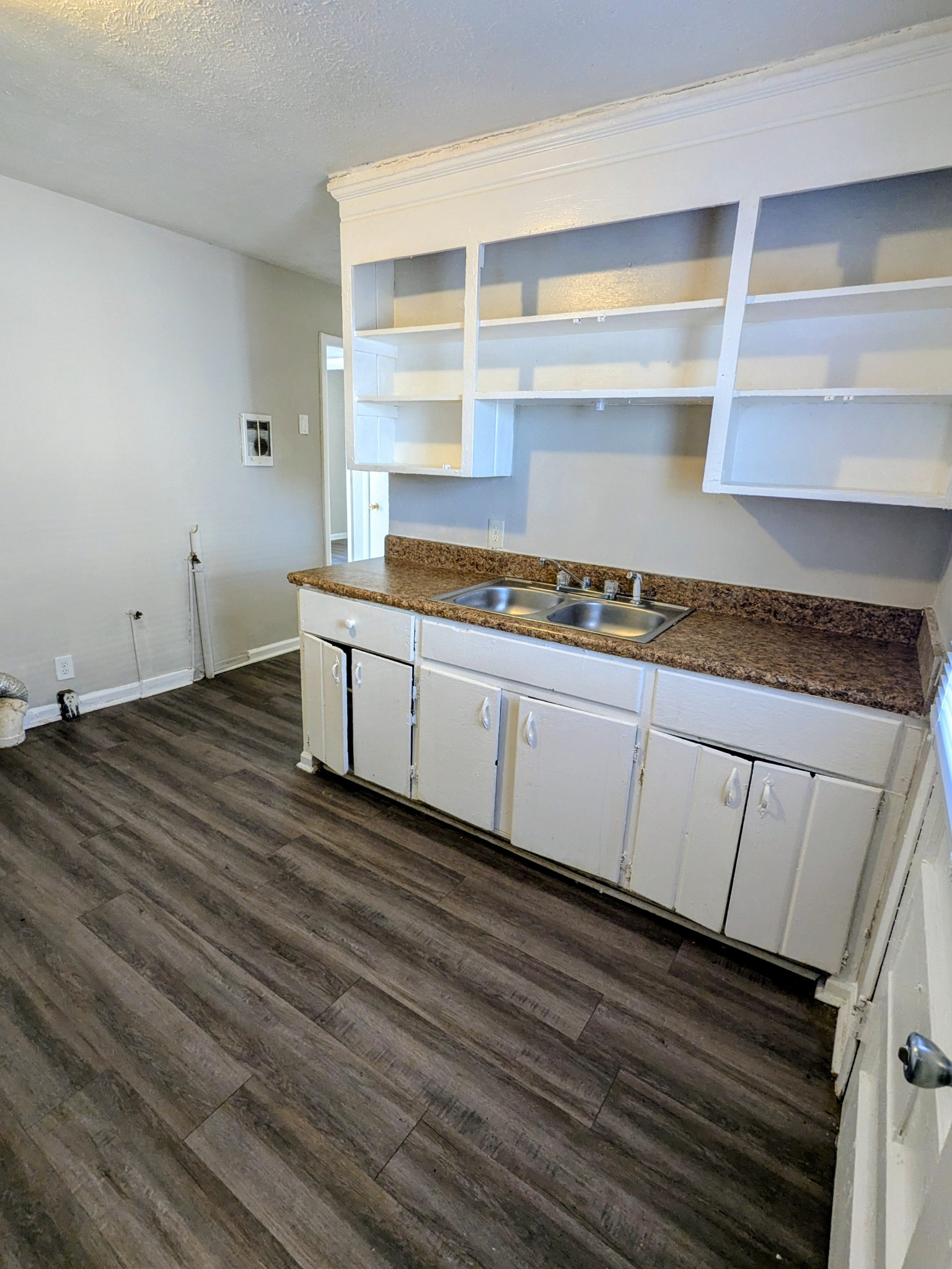 118 Rains Avenue, Unit 2 Nashville, TN 37203 - Photo 3 of 6 a kitchen with wooden floors and white cabinets