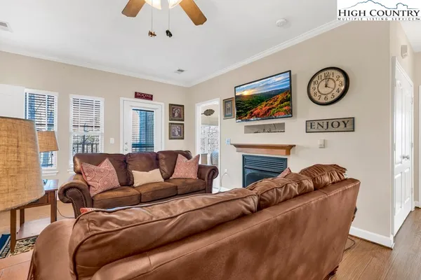 a living room with furniture a fireplace and a window