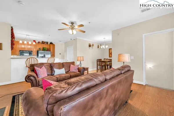 a living room with furniture a couch and a chandelier