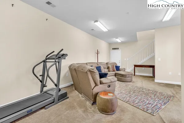 a living room with furniture and a rug