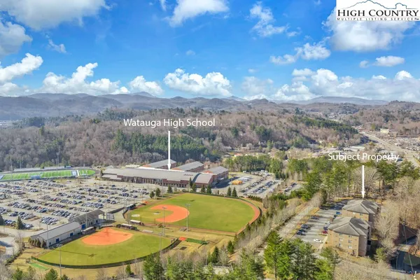 a view of a swimming pool with a yard and mountain view