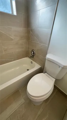 a bathroom with a toilet and a bathtub