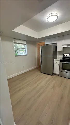 an empty room with a fireplace and painted walls