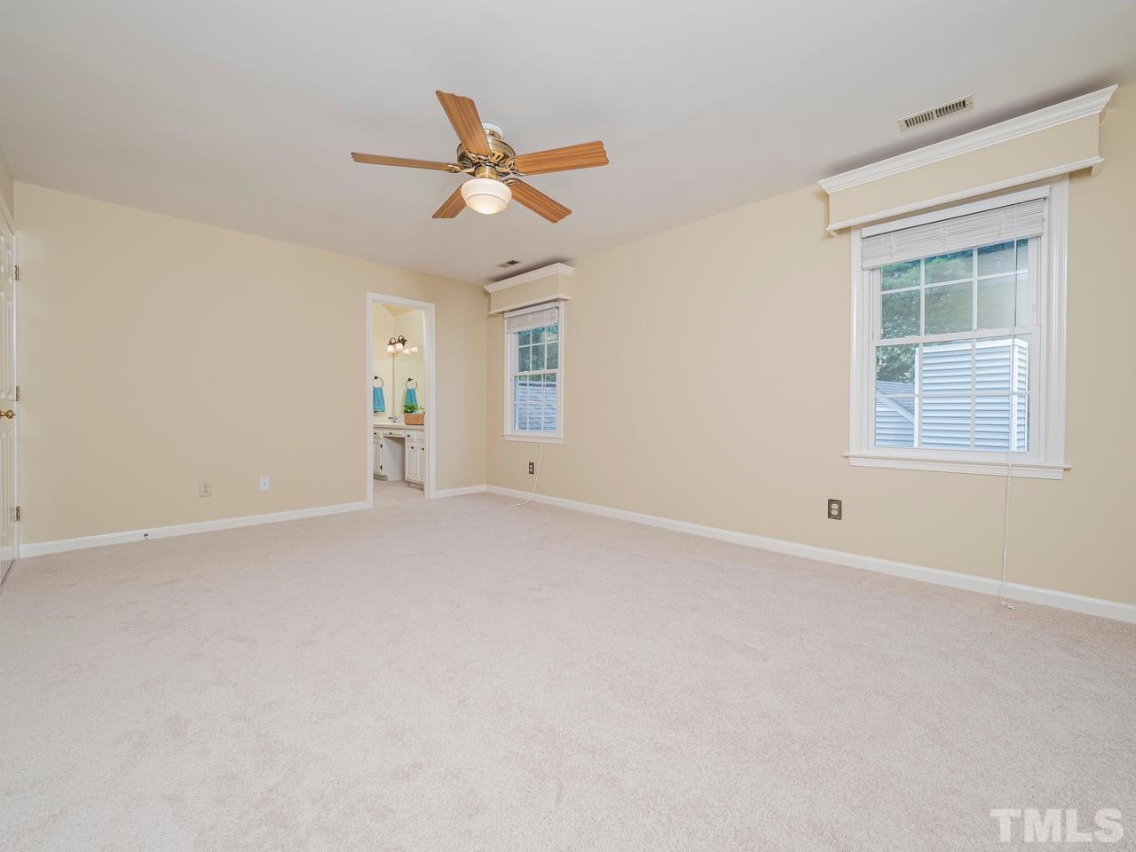 7100 Kinross Drive Raleigh, NC 27613 - Photo 11 of 24 an empty room with a window and ceiling fan