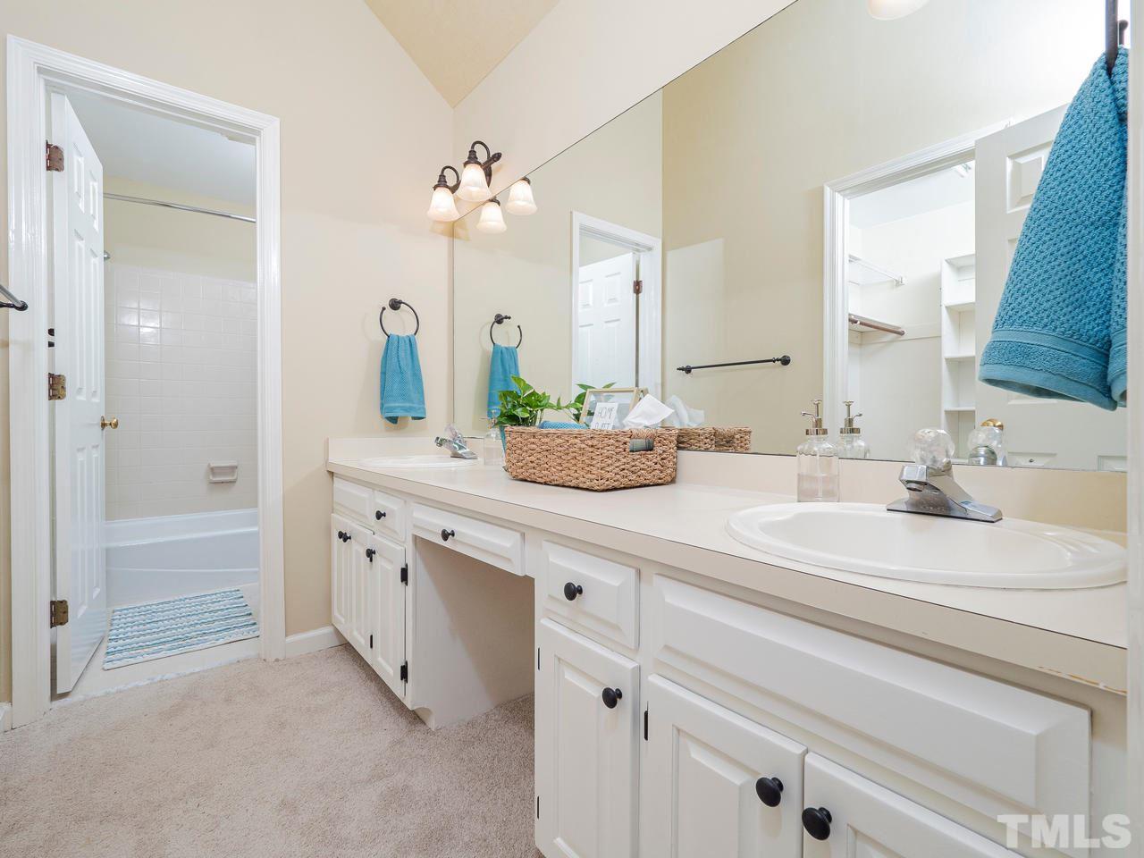 7100 Kinross Drive Raleigh, NC 27613 - Photo 12 of 24 a bathroom with a sink vanity granite tub shower and a mirror