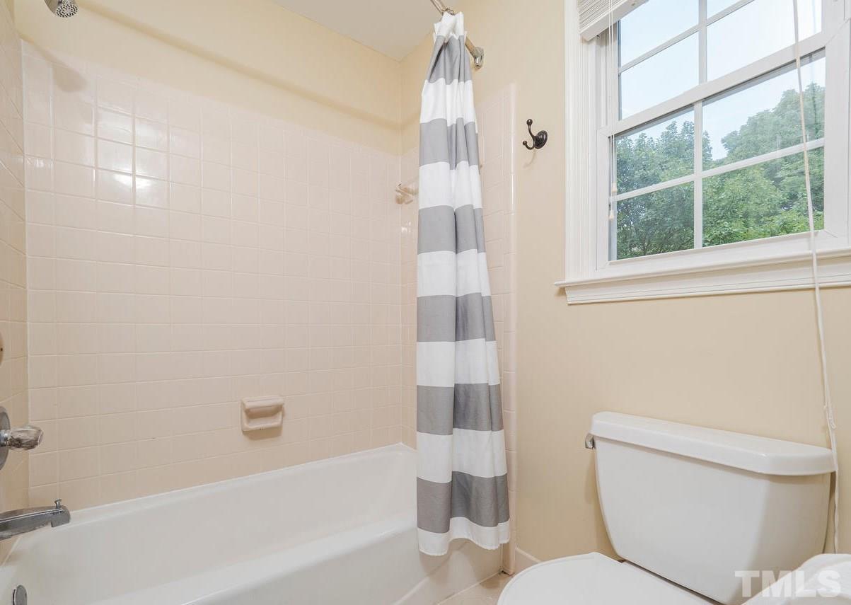 7100 Kinross Drive Raleigh, NC 27613 - Photo 13 of 24 a bathroom with a toilet and shower