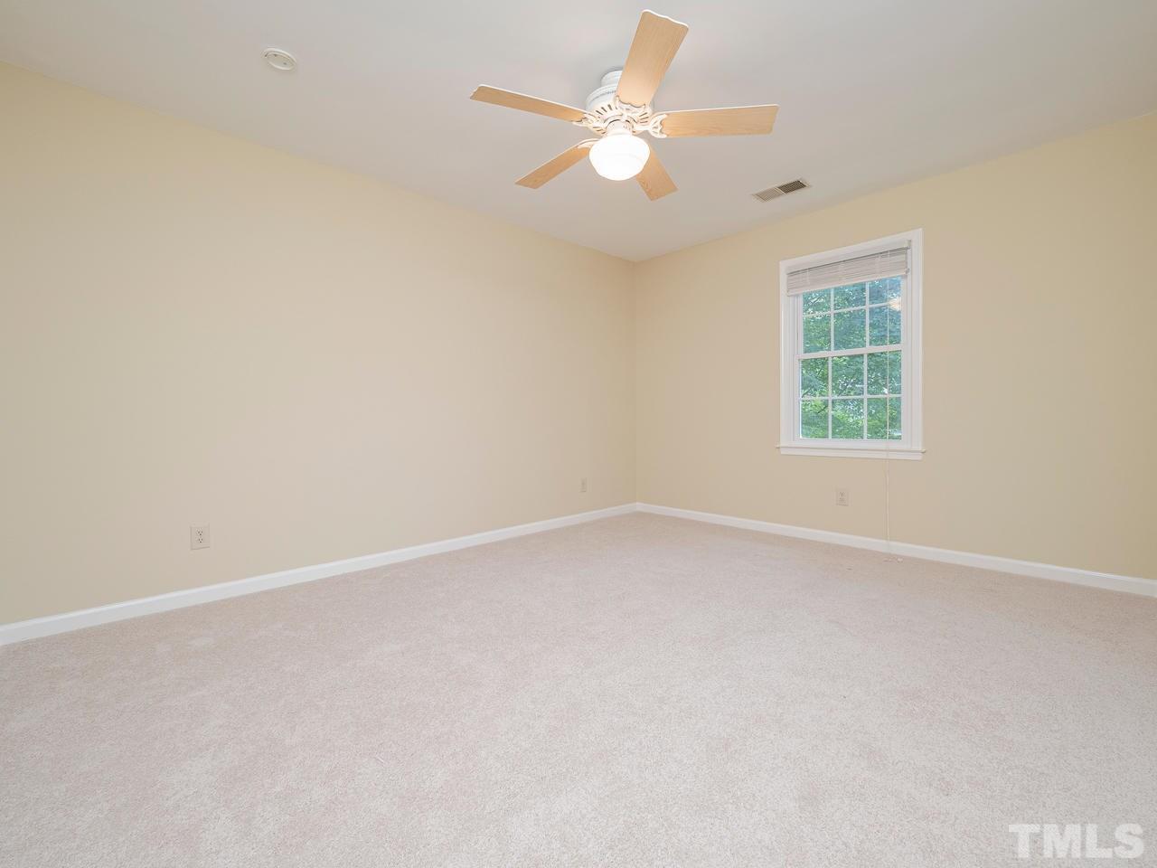 7100 Kinross Drive Raleigh, NC 27613 - Photo 16 of 24 an empty room with a window and a fan
