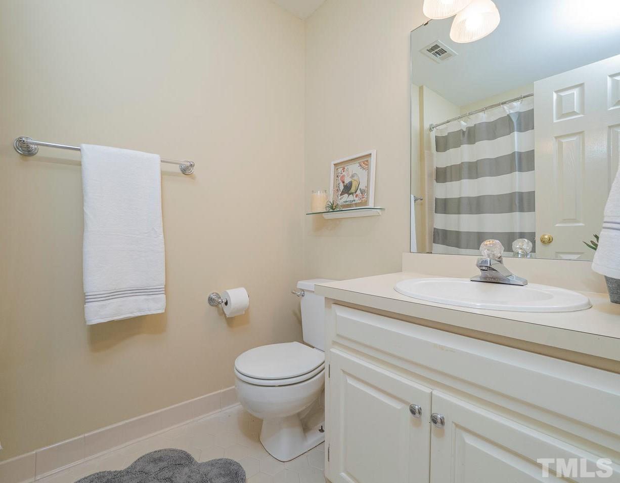 7100 Kinross Drive Raleigh, NC 27613 - Photo 17 of 24 a bathroom with a sink a toilet and a mirror