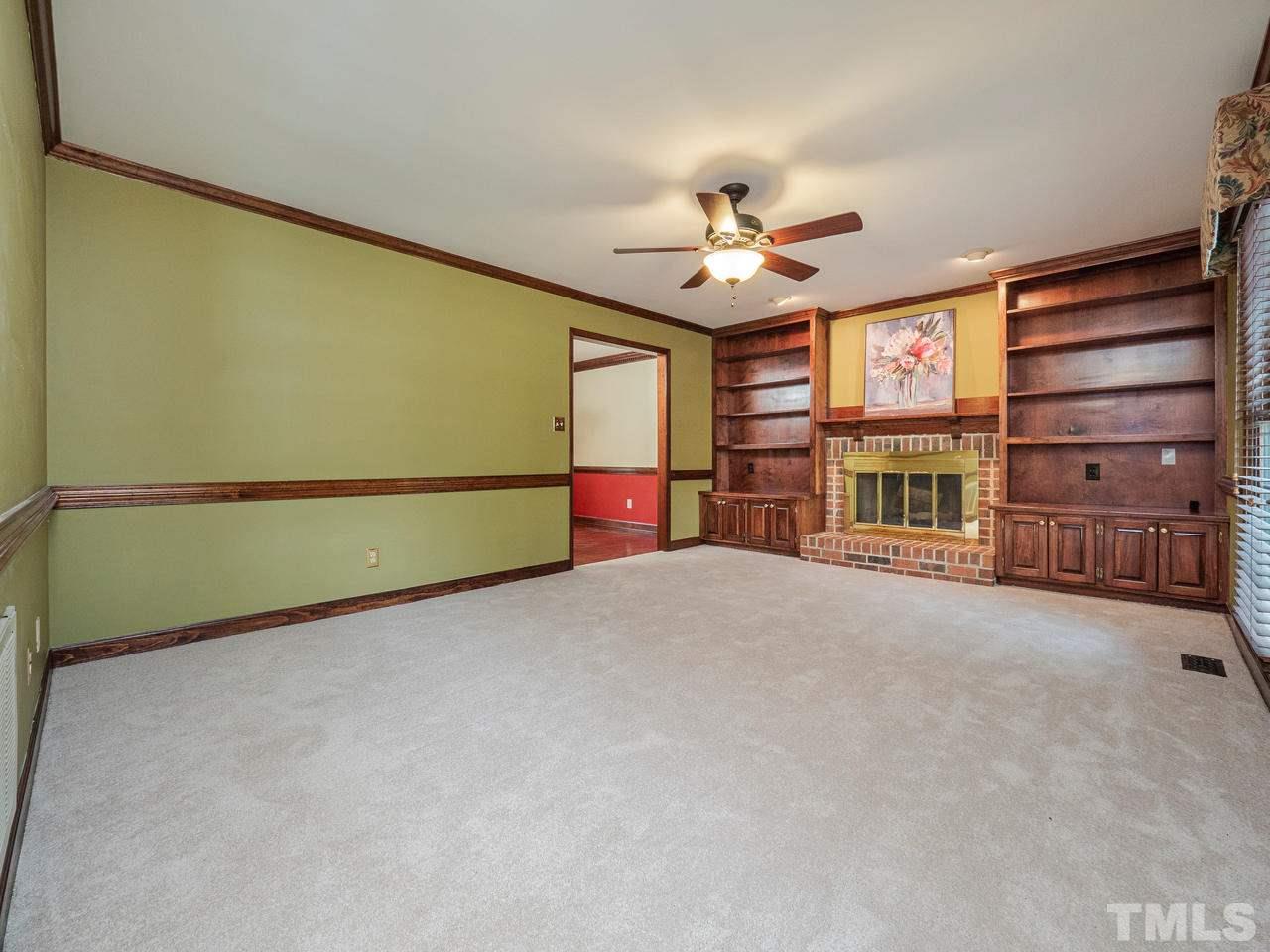 7100 Kinross Drive Raleigh, NC 27613 - Photo 3 of 24 a view of an empty room with a fireplace and a window