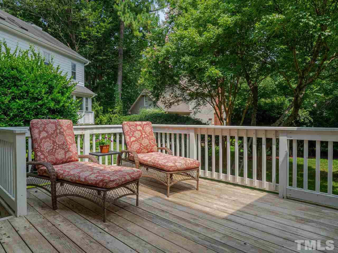 7100 Kinross Drive Raleigh, NC 27613 - Photo 21 of 24 a view of a chair and table on the wooden deck