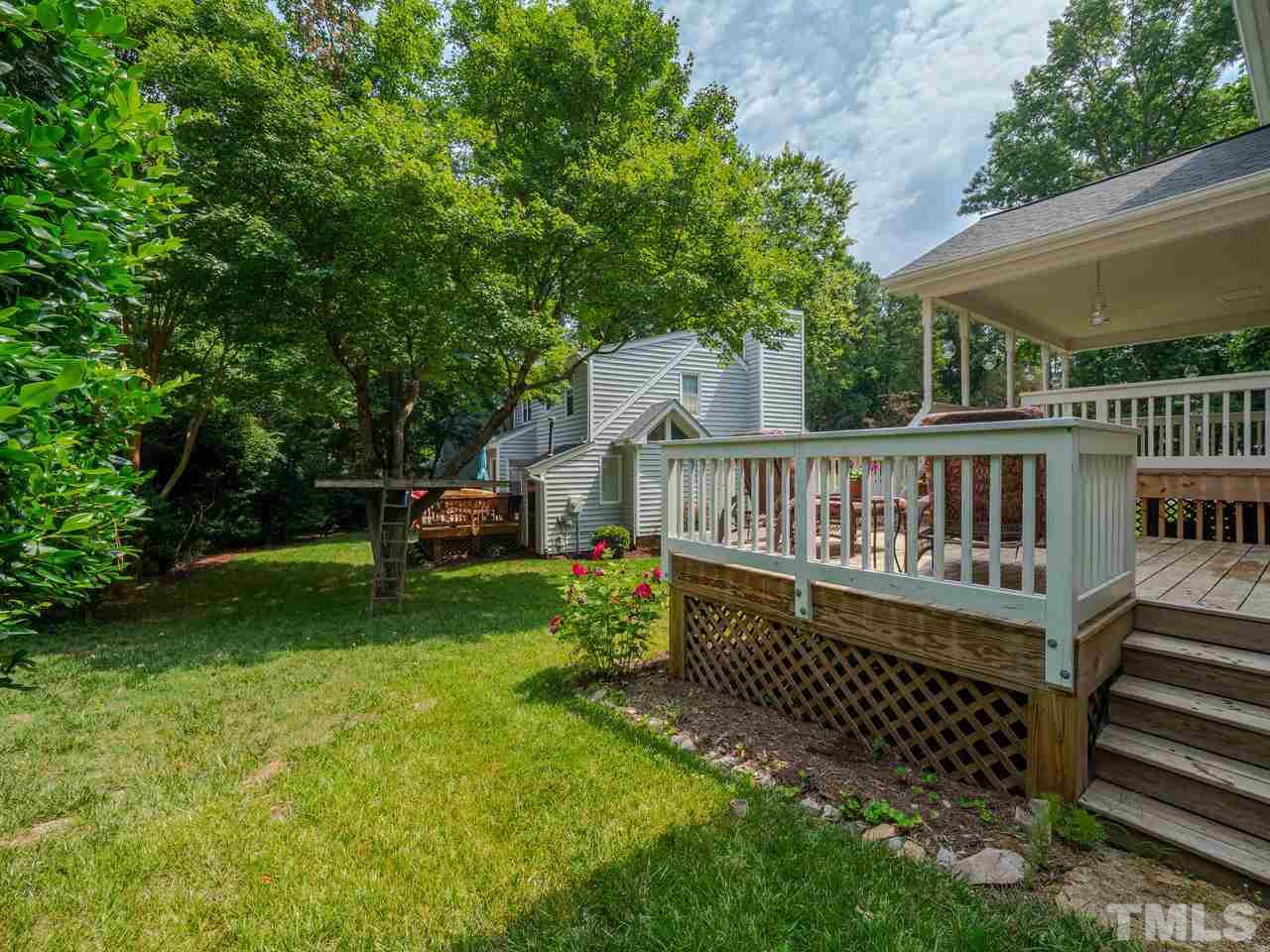 7100 Kinross Drive Raleigh, NC 27613 - Photo 22 of 24 a view of a house with a wooden deck and a yard