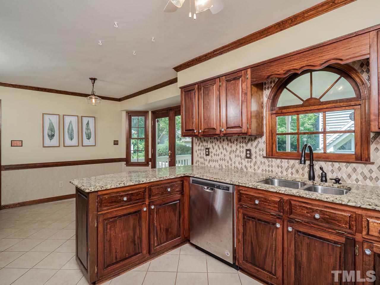 7100 Kinross Drive Raleigh, NC 27613 - Photo 6 of 24 a kitchen with stainless steel appliances granite countertop a sink and a microwave