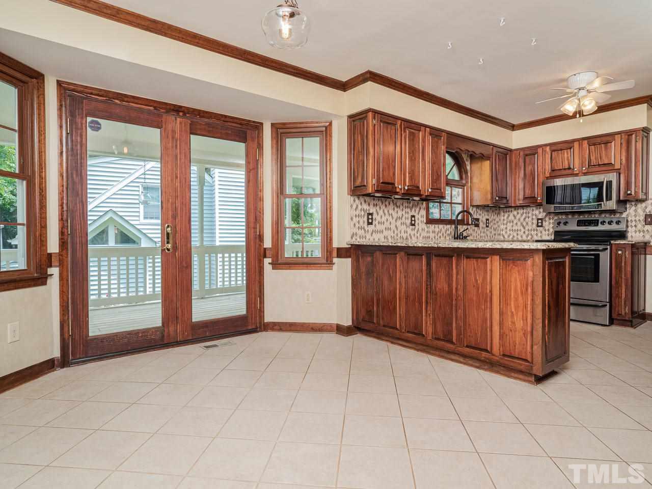 7100 Kinross Drive Raleigh, NC 27613 - Photo 7 of 24 a view of kitchen with stainless steel appliances granite countertop a stove and cabinets