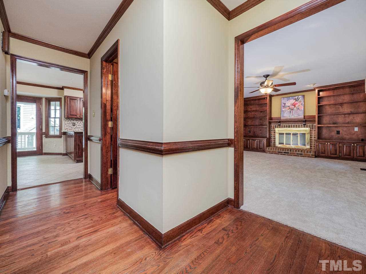 7100 Kinross Drive Raleigh, NC 27613 - Photo 9 of 24 a view of a hallway with wooden floor and furniture