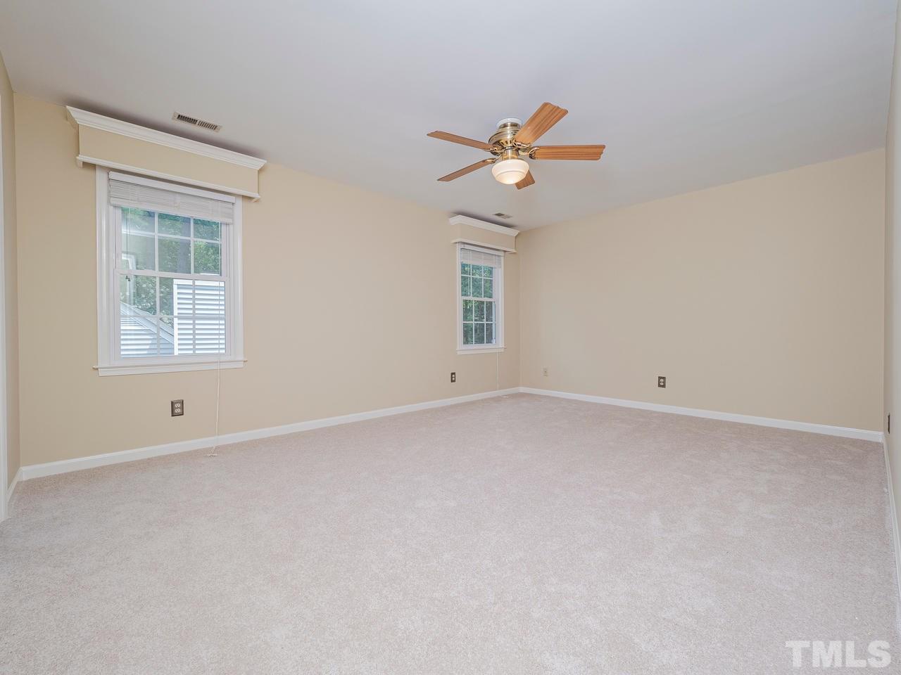 7100 Kinross Drive Raleigh, NC 27613 - Photo 10 of 24 an empty room with a window and ceiling fan