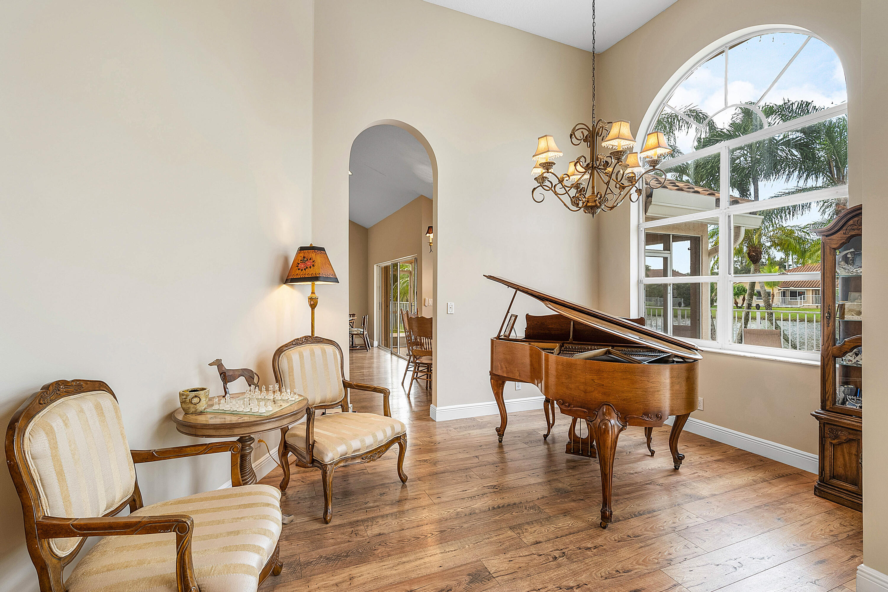 22345 Siesta Key Drive Boca Raton, FL 33428 - Photo 5 of 45 a room with chandelier fan and wooden floor