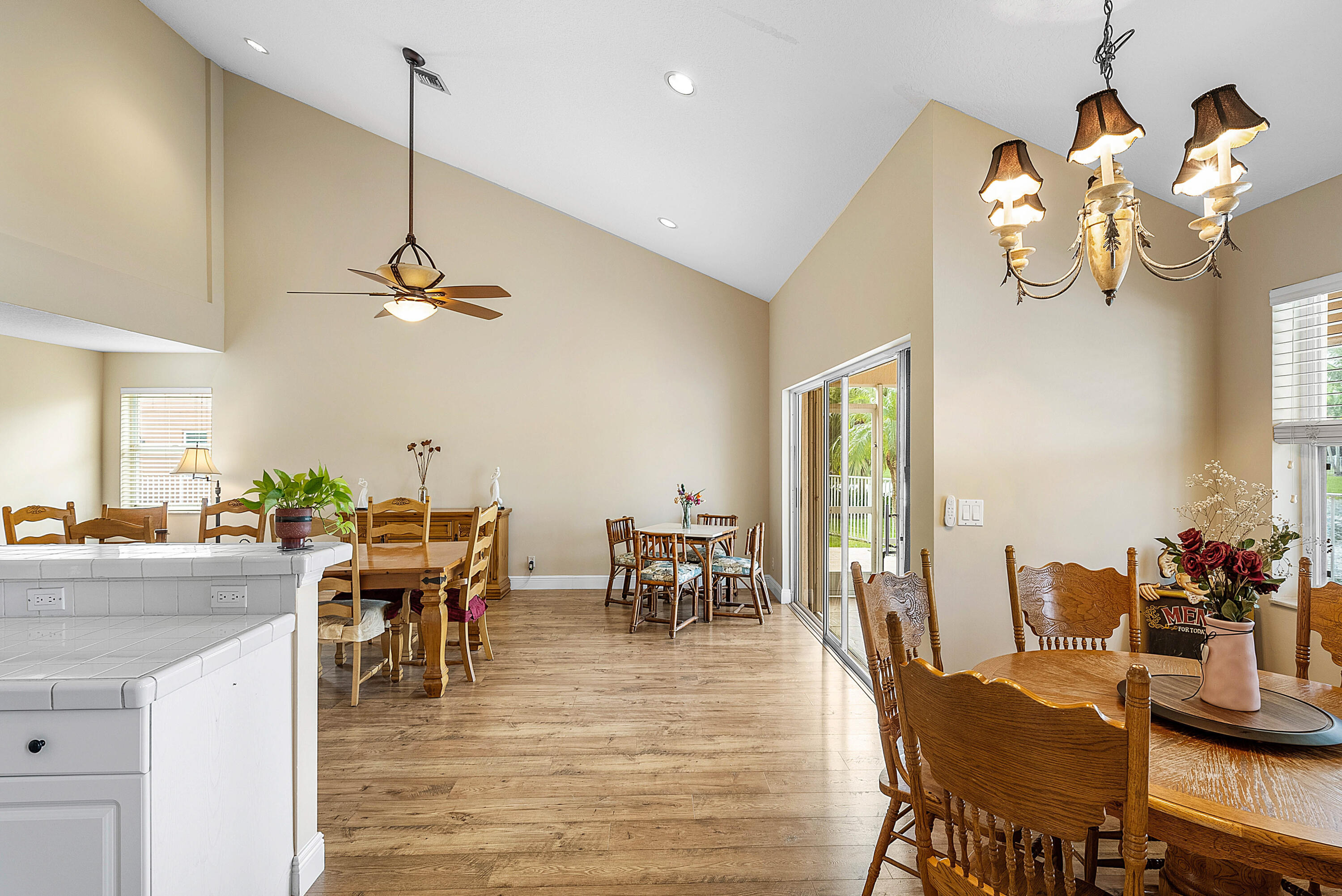 22345 Siesta Key Drive Boca Raton, FL 33428 - Photo 6 of 45 a view of a dining room and livingroom with furniture wooden floor a chandelier