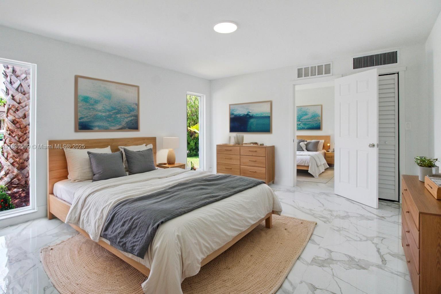 4808 Mango Drive Tamarac, FL 33319 - Photo 11 of 36 a spacious bedroom with a bed a table and a window